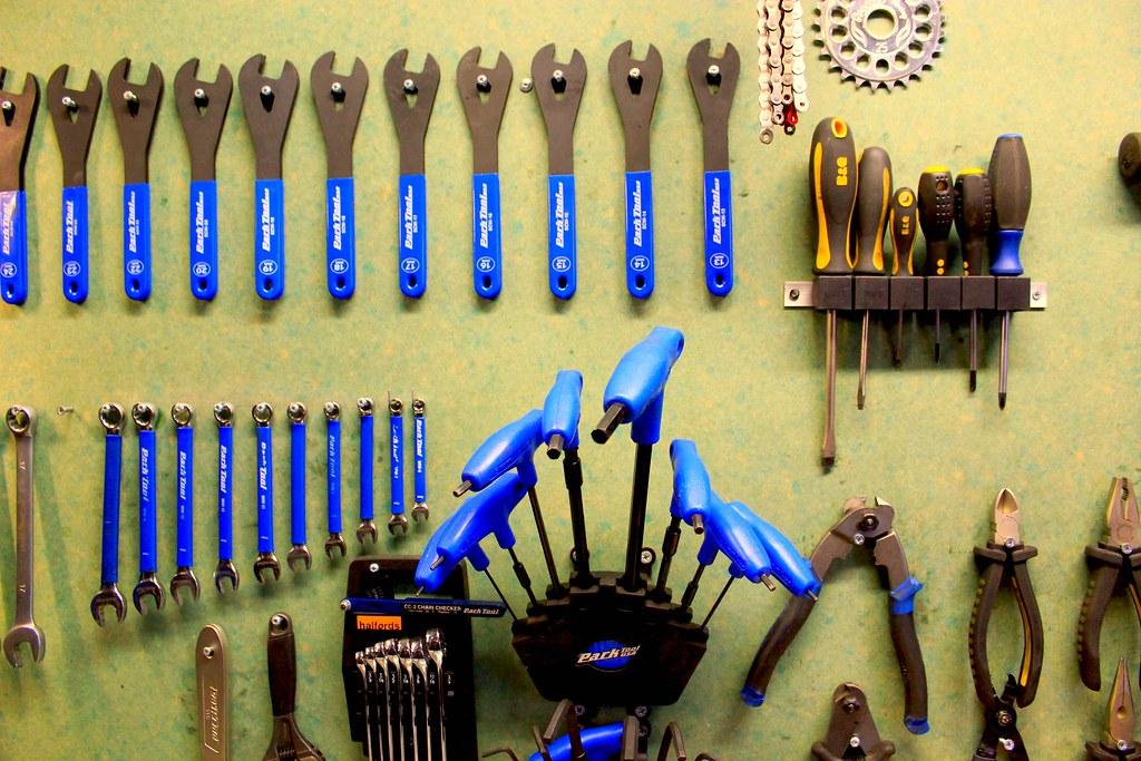 Tools laid out on a bicycle workshop bench